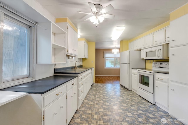 900 29th St SE Unit E-22, Auburn, WA 98002 - kitchen featuring white appliances, open shelves, white cabinetry, dark countertops, and ceiling fan