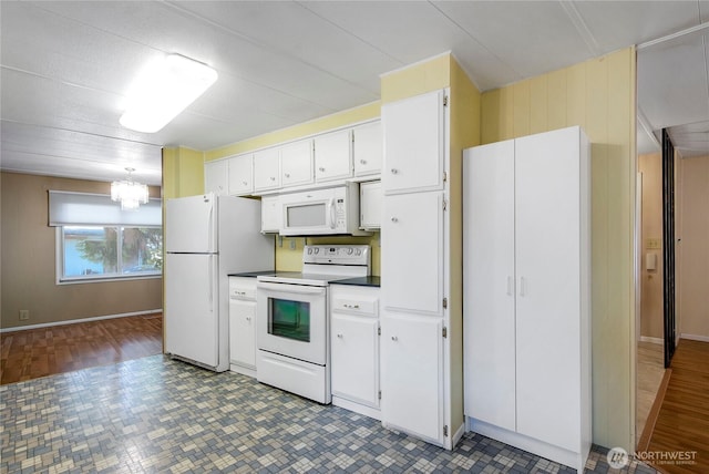 900 29th St SE Unit E-22, Auburn, WA 98002 - kitchen featuring white appliances, white cabinetry, and a chandelier