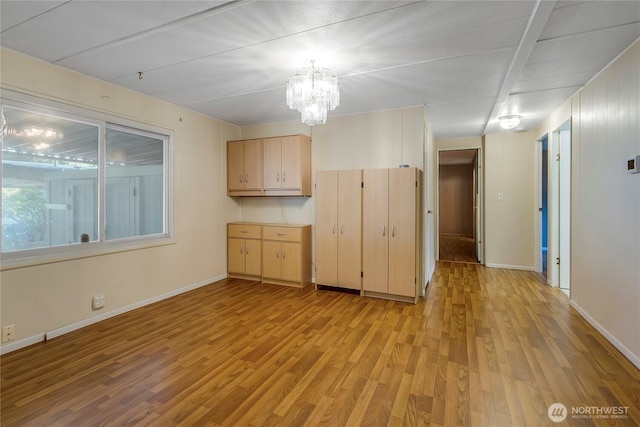 900 29th St SE Unit E-22, Auburn, WA 98002 - kitchen featuring light wood finished floors, a chandelier, light brown cabinets, and hanging light fixtures