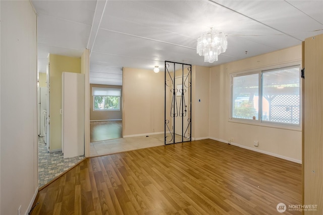 900 29th St SE Unit E-22, Auburn, WA 98002 - spare room featuring a chandelier and wood finished floors