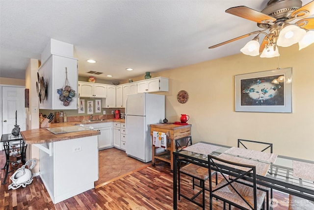 5118 NE 75th Ave, Vancouver, WA 98661 - kitchen with freestanding refrigerator, a ceiling fan, a peninsula, white cabinetry, and recessed lighting