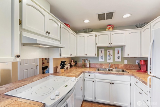 5118 NE 75th Ave, Vancouver, WA 98661 - kitchen featuring stove, under cabinet range hood, white cabinetry, recessed lighting, and freestanding refrigerator