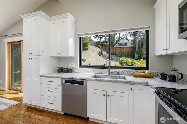 11520 3rd Ave NW, Seattle, WA 98177 - kitchen with appliances with stainless steel finishes, vaulted ceiling, dark wood-type flooring, white cabinets, and light stone counters