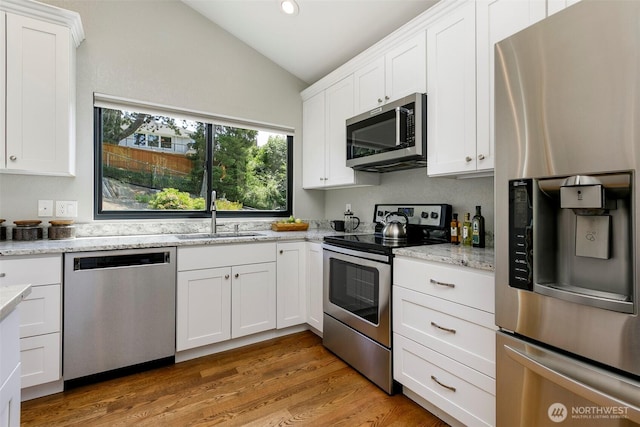 11520 3rd Ave NW, Seattle, WA 98177 - kitchen with appliances with stainless steel finishes, lofted ceiling, white cabinetry, light stone countertops, and recessed lighting