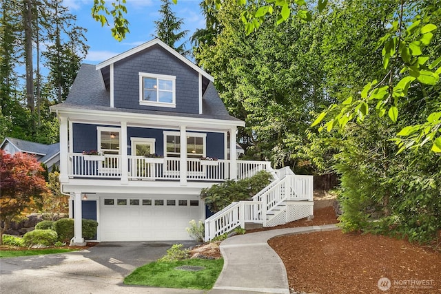 10290 NE Ruddy Duck Ln, Bainbridge Island, WA 98110 - view of front facade featuring asphalt driveway, covered porch, stairs, an attached garage, and a shingled roof