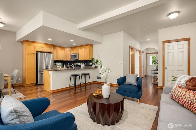 10290 NE Ruddy Duck Ln, Bainbridge Island, WA 98110 - living area featuring arched walkways, light wood finished floors, and recessed lighting