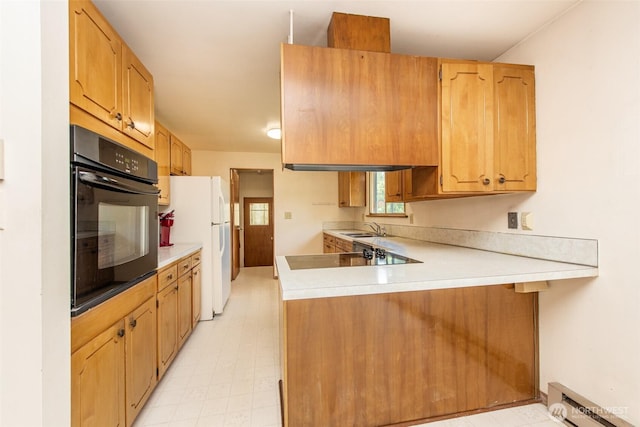 723 W 15th St, Port Angeles, WA 98363 - kitchen with black appliances, a baseboard heating unit, a peninsula, and light countertops