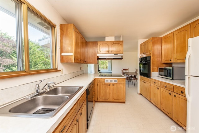 723 W 15th St, Port Angeles, WA 98363 - kitchen featuring black appliances, light countertops, a peninsula, light flooring, and under cabinet range hood