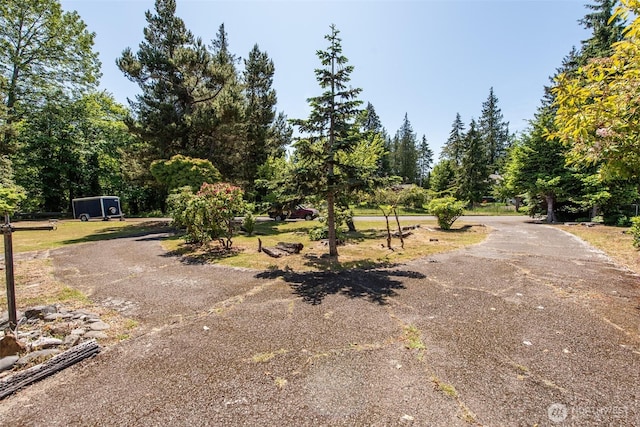 723 W 15th St, Port Angeles, WA 98363 - view of asphalt driveway featuring view of wooded area