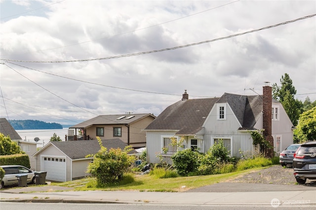 7936 E Main St, Port Orchard, WA 98366 - view of front facade featuring a chimney, an outbuilding, and a shingled roof