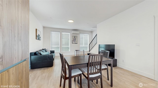 1300 E Remington Ct Unit A, Seattle, WA 98122 - dining room featuring light wood-style floors, stairway, and a wall mounted air conditioner