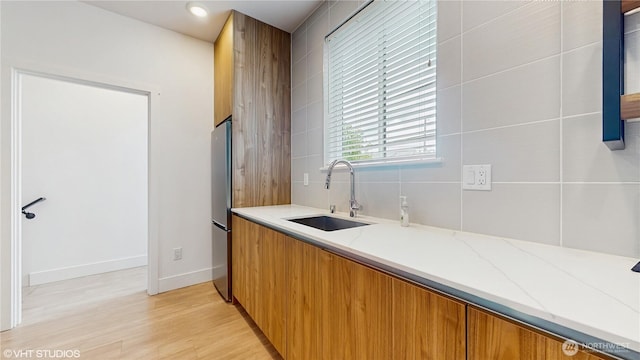 1300 E Remington Ct Unit A, Seattle, WA 98122 - bar with light wood-type flooring and freestanding refrigerator