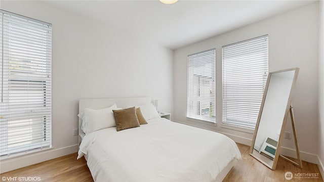 1300 E Remington Ct Unit A, Seattle, WA 98122 - bedroom with light wood-style flooring and baseboards