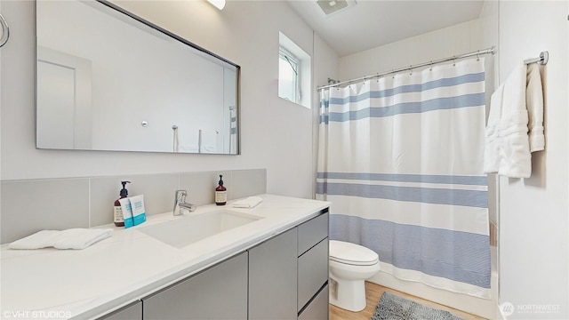 1300 E Remington Ct Unit A, Seattle, WA 98122 - full bathroom featuring vanity, wood finished floors, and a shower with shower curtain
