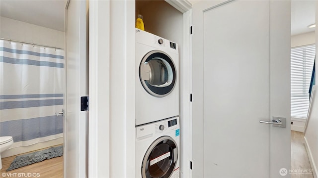 1300 E Remington Ct Unit A, Seattle, WA 98122 - laundry room featuring stacked washing machine and dryer and wood finished floors