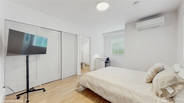 1300 E Remington Ct Unit A, Seattle, WA 98122 - bedroom with a wall unit AC, light wood finished floors, and ensuite bathroom
