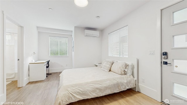 1300 E Remington Ct Unit A, Seattle, WA 98122 - bedroom featuring a wall unit AC and light wood-style floors