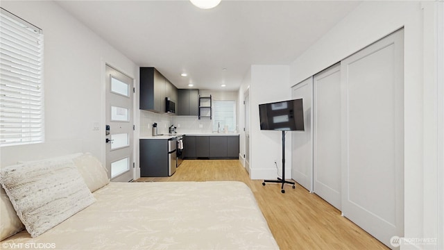1300 E Remington Ct Unit A, Seattle, WA 98122 - kitchen with backsplash, light wood-style flooring, open shelves, plenty of natural light, and recessed lighting