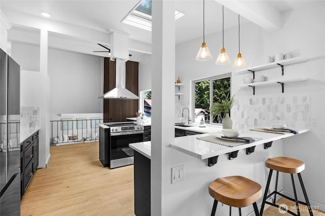 20201 45th Dr SE, Bothell, WA 98012 - kitchen with electric range, wall chimney exhaust hood, open shelves, a kitchen breakfast bar, and light wood-style flooring