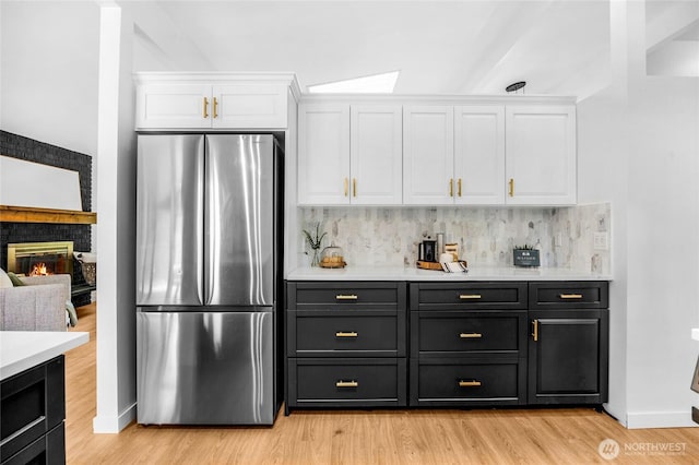 20201 45th Dr SE, Bothell, WA 98012 - kitchen with freestanding refrigerator, white cabinets, light countertops, and backsplash