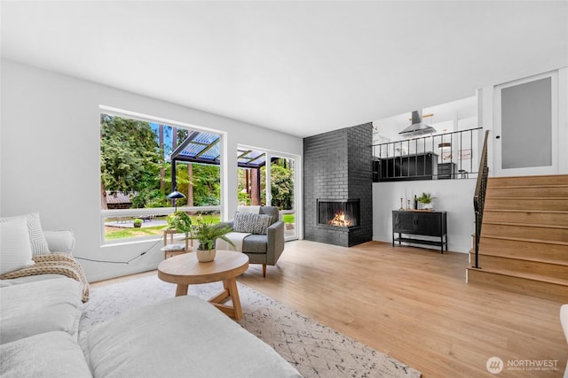 20201 45th Dr SE, Bothell, WA 98012 - living area featuring light wood-style flooring, stairway, and a fireplace