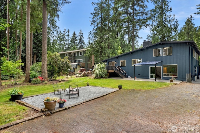 20201 45th Dr SE, Bothell, WA 98012 - back of property with a fire pit, a patio, a chimney, and a yard