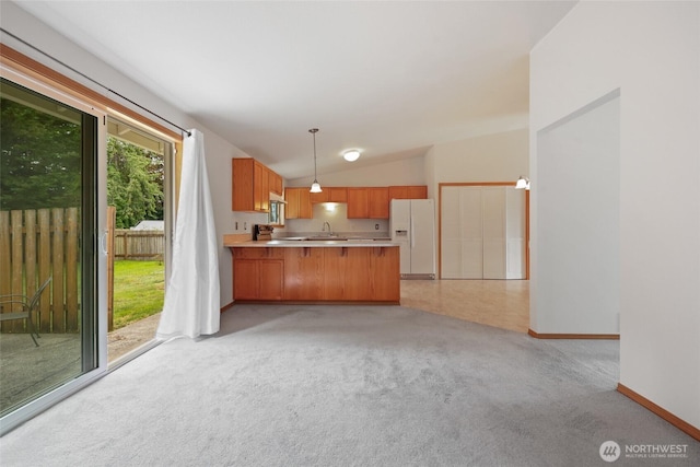 421 E Marion St, Aberdeen, WA 98520 - kitchen featuring white refrigerator with ice dispenser, a peninsula, light countertops, light carpet, and vaulted ceiling