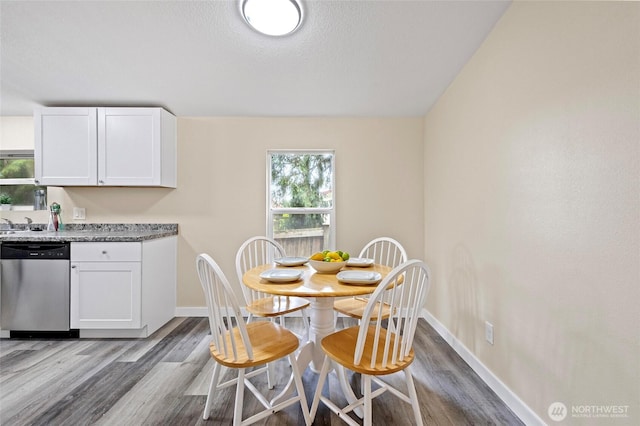 1320 N Oak Harbor St Unit 1, Oak Harbor, WA 98277 - dining space featuring healthy amount of natural light, dark wood finished floors, and a textured ceiling