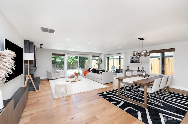 18114 NE 23rd St, Redmond, WA 98052 - living room with light wood finished floors, plenty of natural light, a chandelier, and recessed lighting