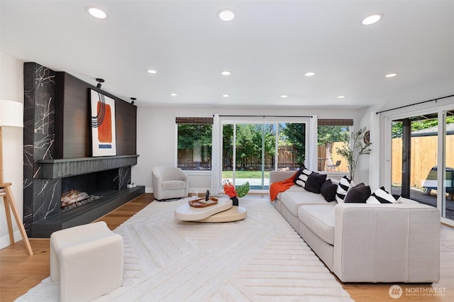 18114 NE 23rd St, Redmond, WA 98052 - living room with recessed lighting, wood finished floors, and a high end fireplace