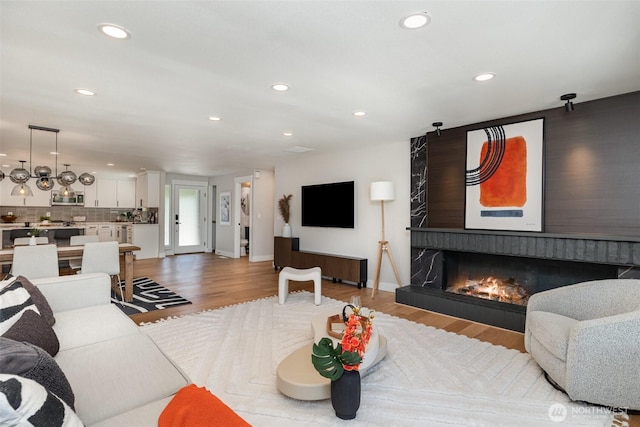 18114 NE 23rd St, Redmond, WA 98052 - living room featuring wood finished floors, recessed lighting, and a lit fireplace