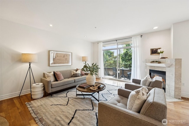 2551 Thorndyke Ave W Unit 203, Seattle, WA 98199 - living room with a tile fireplace, wood finished floors, and recessed lighting