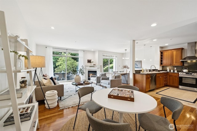 2551 Thorndyke Ave W Unit 203, Seattle, WA 98199 - dining room featuring light wood-style flooring, recessed lighting, and a glass covered fireplace