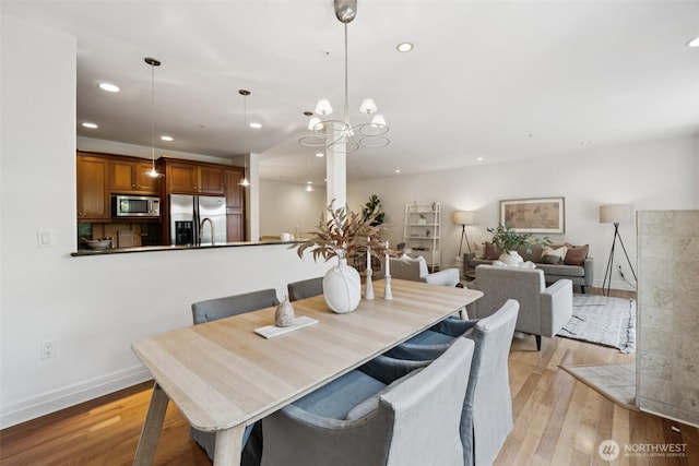 2551 Thorndyke Ave W Unit 203, Seattle, WA 98199 - dining room featuring light wood finished floors, recessed lighting, and a chandelier