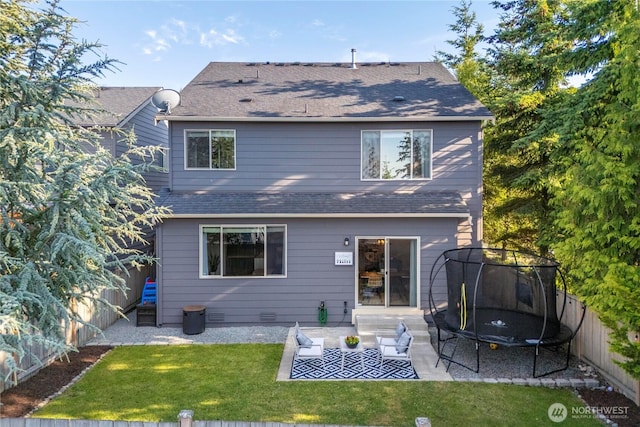 2211 56th St SE, Auburn, WA 98092 - rear view of property featuring a shingled roof, a trampoline, a fenced backyard, and a patio