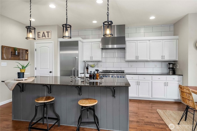 2211 56th St SE, Auburn, WA 98092 - kitchen featuring wall chimney exhaust hood, stainless steel built in refrigerator, dark wood-style floors, white cabinets, and recessed lighting