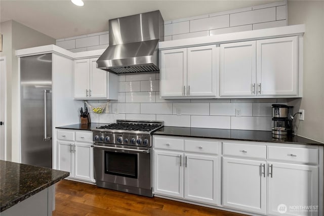 2211 56th St SE, Auburn, WA 98092 - kitchen featuring wall chimney range hood, high end appliances, tasteful backsplash, and white cabinetry