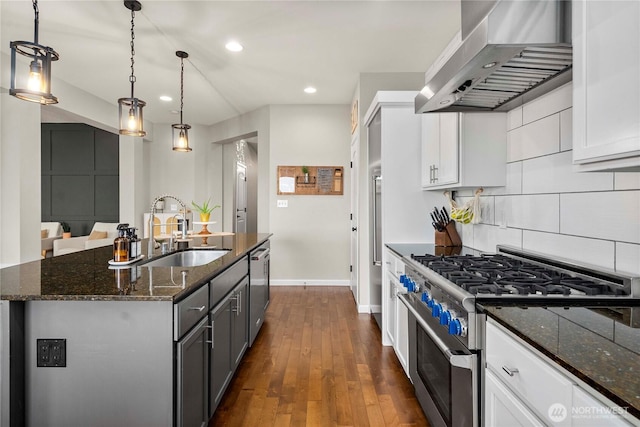 2211 56th St SE, Auburn, WA 98092 - kitchen featuring stainless steel appliances, range hood, backsplash, dark wood-style flooring, and dark stone countertops