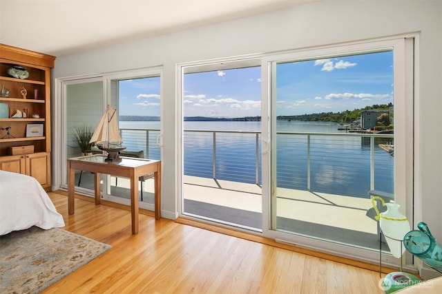 414 Lakeside Ave S Unit 13, Seattle, WA 98144 - bedroom featuring access to outside, wood finished floors, and a water view
