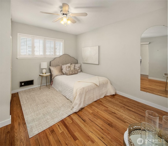 414 Lakeside Ave S Unit 13, Seattle, WA 98144 - bedroom featuring arched walkways, wood finished floors, and ceiling fan