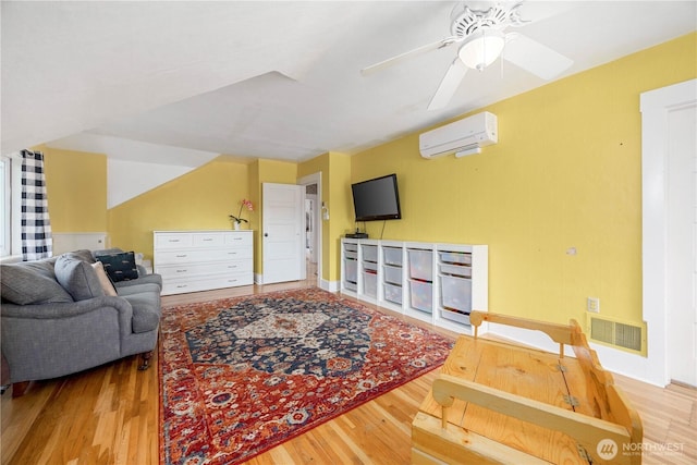 902 Washington St, Wenatchee, WA 98801 - living room with a wall mounted AC, wood finished floors, and a ceiling fan