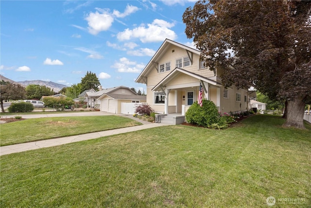 902 Washington St, Wenatchee, WA 98801 - view of front of property featuring a garage, a front yard, concrete driveway, covered porch, and a mountain view