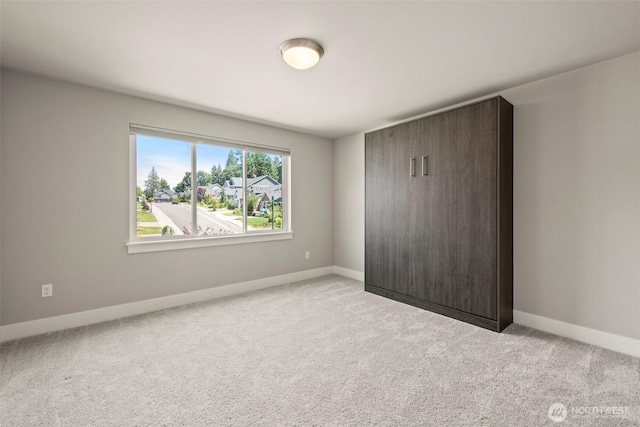 7176 Teal Loop, Gig Harbor, WA 98335 - unfurnished bedroom featuring light carpet and baseboards