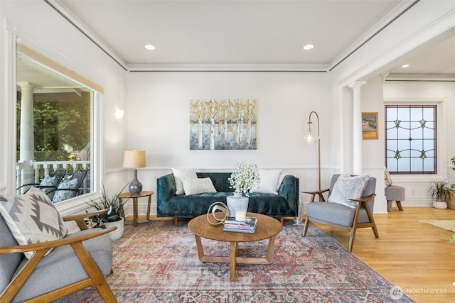 2707 4th Ave W, Seattle, WA 98119 - living area with decorative columns, ornamental molding, wood finished floors, healthy amount of natural light, and recessed lighting