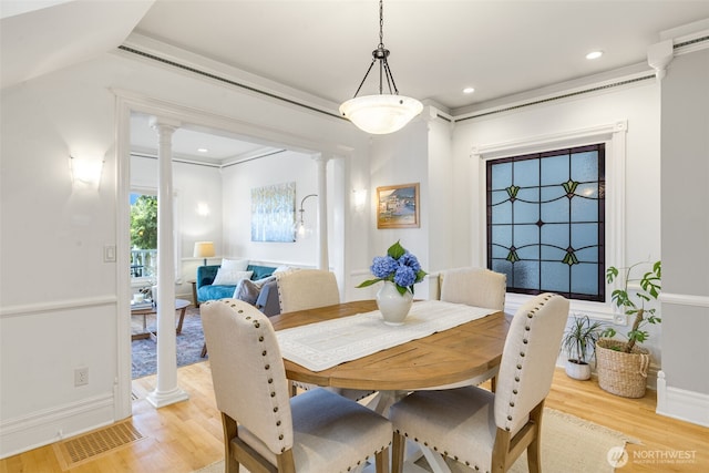 2707 4th Ave W, Seattle, WA 98119 - dining space with decorative columns, light wood-style flooring, and recessed lighting