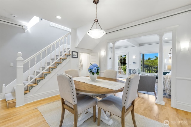 2707 4th Ave W, Seattle, WA 98119 - dining space with ornate columns, wood finished floors, stairway, and recessed lighting