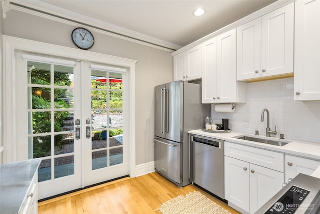 2707 4th Ave W, Seattle, WA 98119 - kitchen featuring stainless steel appliances, decorative backsplash, white cabinets, light countertops, and recessed lighting