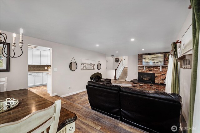 4121 54th Street Ct NW, Gig Harbor, WA 98335 - living room featuring wood finished floors, a fireplace, recessed lighting, and stairs