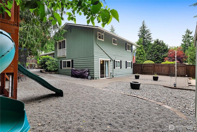 4121 54th Street Ct NW, Gig Harbor, WA 98335 - back of property with a playground, a patio area, and a fenced backyard