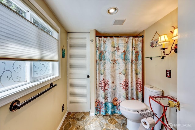 16300 NE State Highway 305 Unit 18, Poulsbo, WA 98370 - bathroom featuring plenty of natural light, stone finish flooring, and a shower with shower curtain